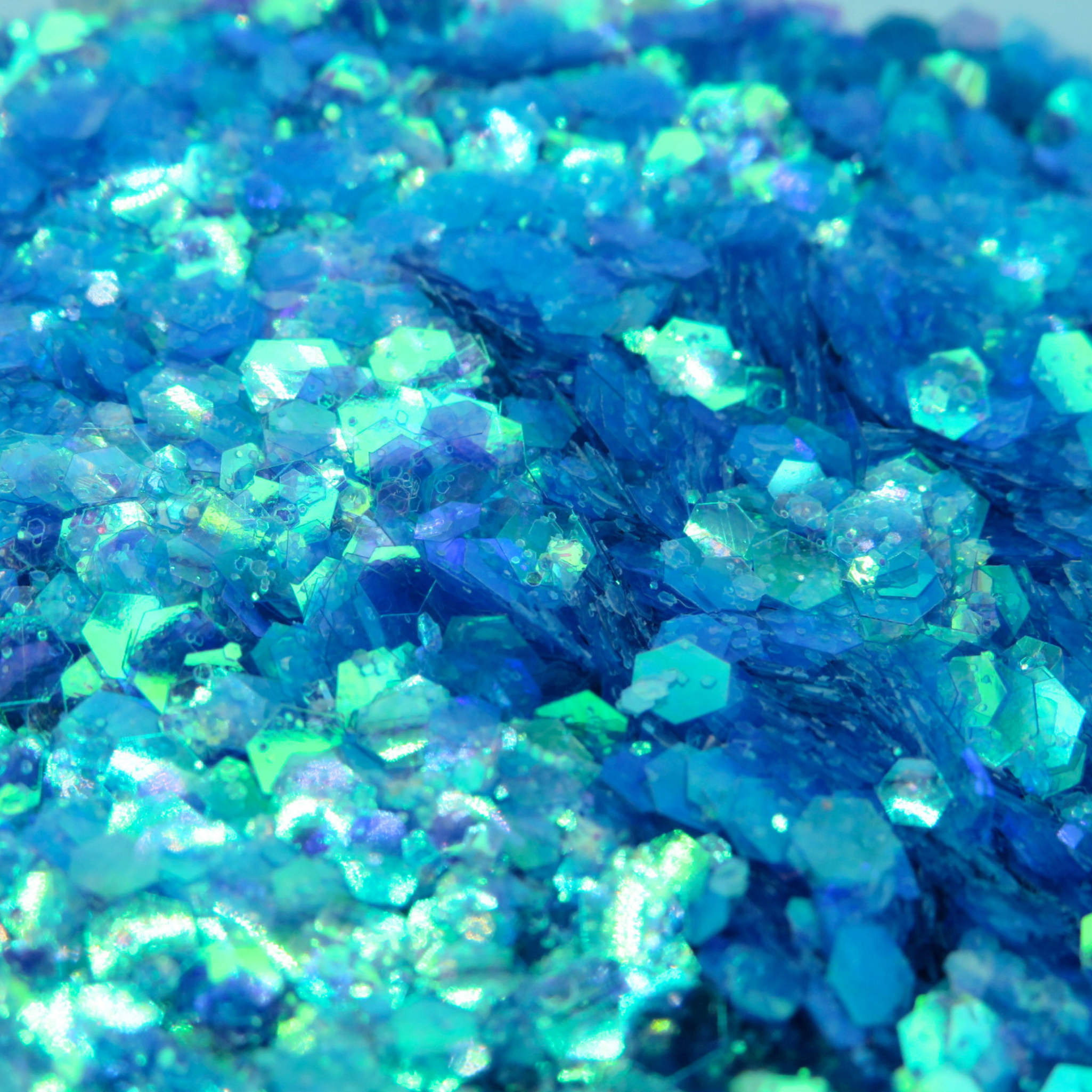 Close-up of blue iridescent glitter with a sparkling effect