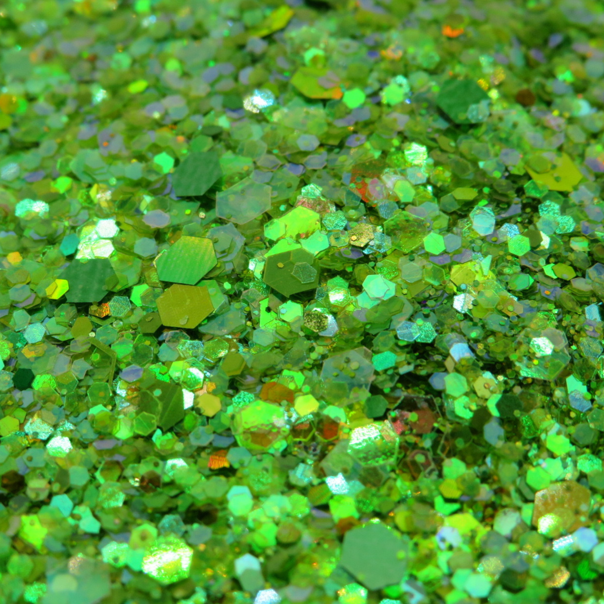 Close-up of green holographic glitter with multicolour iridescent sparkle effect