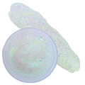 Clear iridescent festival glitter gel with a swipe of the gel behind it on a white background. The glitter gel is in a clear plastic pot