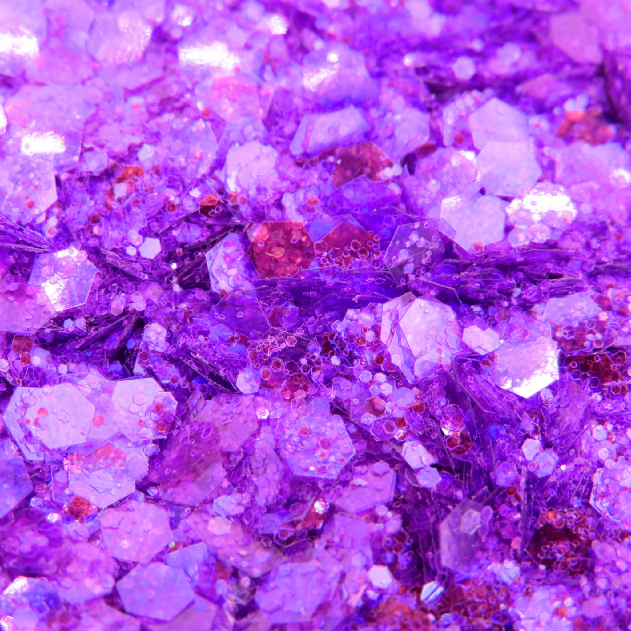 Close-up of purple glitter with reflective properties
